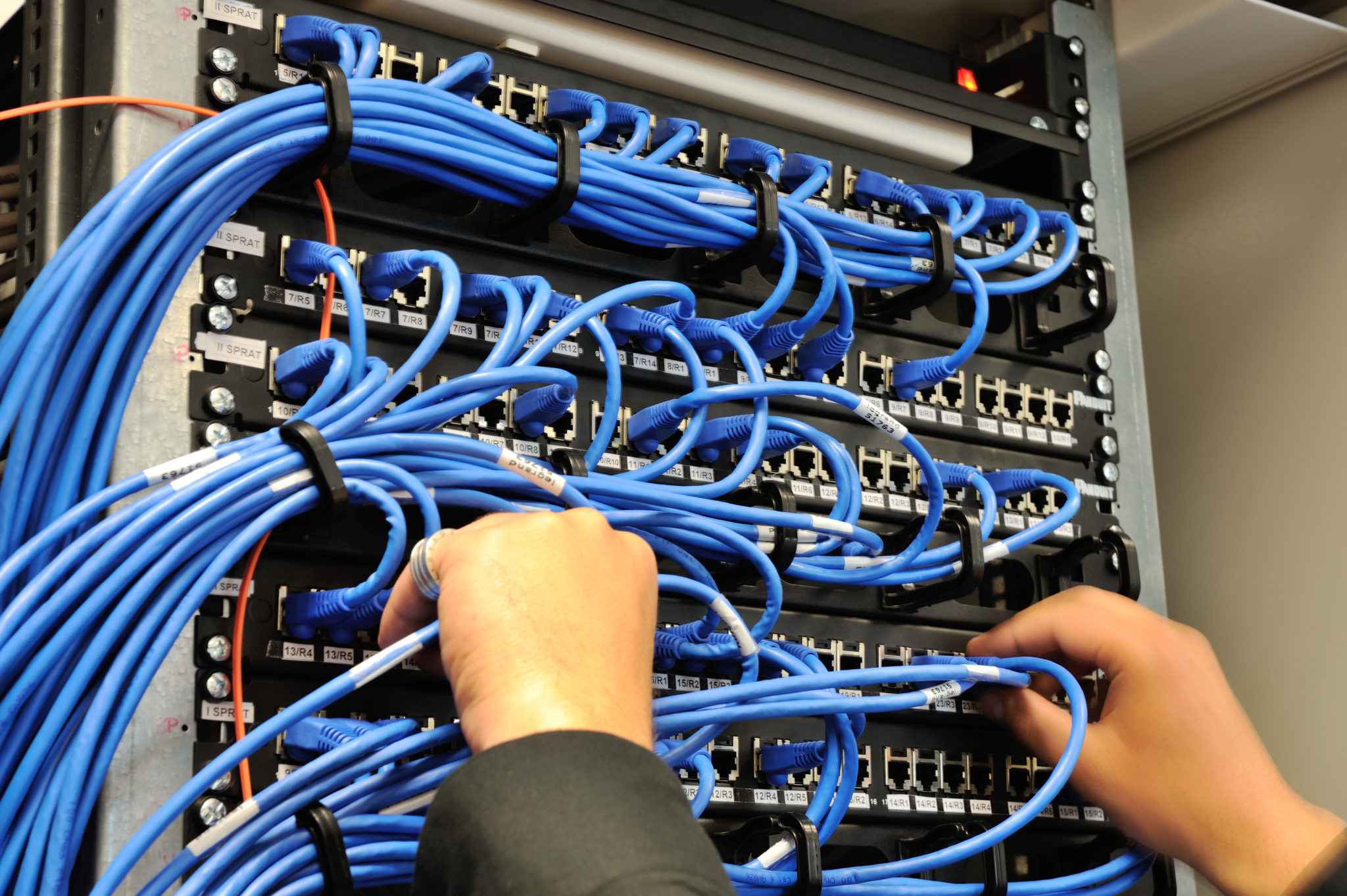 Man,Connecting,Network,Cables,To,Switches